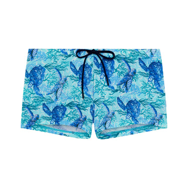 Blue swim shorts with turtle pattern on a white background